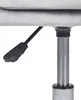 A close-up view of the height adjustment lever and gas lift cylinder of an office chair. Náhled obrázku produktu