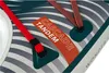 A close-up view of a kayak or canoe, showing straps, a label, and part of the patterned surface. Voir les images du produit