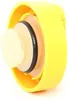 A close-up, angled view of a yellow plastic cap with internal beige and black rubber seals. Náhled obrázku produktu