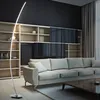 A modern living room with a sofa, bookshelf, and a floor lamp. Náhled obrázku produktu