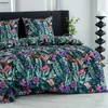 A close-up view of a bed with a floral and monkey-patterned duvet cover and pillowcases. Produktbild-Vorschau