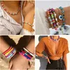 A collage of four images showcasing various colorful beaded jewelry, including necklaces and bracelets, worn by people. Produktbild-Vorschau