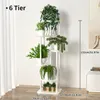 A white, multi-tiered plant stand filled with various green plants, set against a white wall and light wood floor. Produktbild-Vorschau