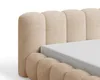 A close-up view of a bed frame with a padded headboard and a mattress. Voir les images du produit