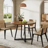 A round wooden dining table with four chairs in a dining room setting. Podgląd zdjęcia produktu