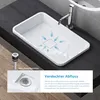 A white rectangular sink with a faucet and a diagram showing water flow towards the drain. A close-up of the drain assembly is shown in a separate inset. The sink is placed on a dark countertop. Anteprima dell’immagine prodotto