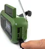 A hand is inserting a USB drive into a green emergency radio. The radio has a solar panel on top and an antenna extended. Produktbild-Vorschau
