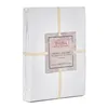 A folded white duvet cover is presented on a white background, secured by two beige straps. A product tag is attached to the front. Produktbild-Vorschau