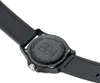 The back of a black watch with a black strap is shown in close-up against a white background. Voir les images du produit
