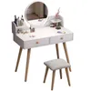 A white vanity table with a round mirror and a stool, set against a white background. Produktbild-Vorschau