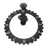 A black gear-shaped wall clock with white numbers and black gears in the center, isolated on a white background. Voir les images du produit