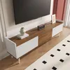 A modern TV stand with a TV mounted above it, in a well-lit room with a rug on the floor. Náhled obrázku produktu