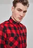 Close-up portrait of a man wearing a red and black checkered flannel shirt. Produktbild-Vorschau