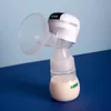 A white and gray electric breast pump with a clear funnel and a bottle containing milk, set against a light blue and dark blue background. Podgląd zdjęcia produktu