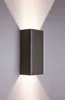 A dark gray, rectangular wall light fixture mounted on a light gray wall, emitting light upwards and downwards. Produktbild-Vorschau