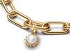 A close-up shot of a gold chain bracelet with a pearl and sun charm. Produktbild-Vorschau