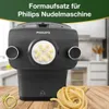 A Philips pasta maker with pasta extruding from it, and a pile of freshly made pasta on a wooden table. Produktbild-Vorschau