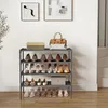 A multi-tiered shoe rack filled with various shoes, with a handbag and a decorative box on top. Náhled obrázku produktu