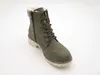 A single green boot with white fur lining and brown laces is shown against a white background. Produktbild-Vorschau