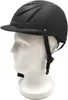 A black riding helmet on a white mannequin head, shown from the side. Náhled obrázku produktu