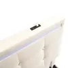 A close-up view of the headboard of a bed, showing integrated USB ports and LED lighting. Produktbild-Vorschau