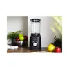 A black blender with a glass jug sits on a wooden countertop, next to a bowl of apples and a pear and an apple. Náhled obrázku produktu