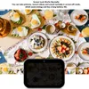 A table laden with breakfast foods, including waffles, eggs, and strawberries, with a digital device in the foreground displaying a darkened screen. Produktbild-Vorschau
