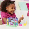 A young girl is playing with a toy playset. Náhľad obrázku produktu