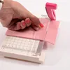 A hand is using a pink and white paper cutter to cut a piece of pink felt. Anteprima dell’immagine prodotto