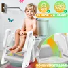 A young child sitting on a step stool next to a toilet. Produktbild-Vorschau