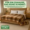 A bedroom scene with a bed made with a plaid merino wool blanket. Produktbild-Vorschau