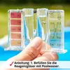 A hand holding a pool water test kit with water in the vials, with a pool in the background. Produktbild-Vorschau