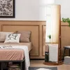 A bedroom scene with a bed, pillows, and a freestanding jewelry cabinet with a mirror. Voir les images du produit