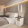 A modern bedroom with a bed and a nightstand. Voir les images du produit
