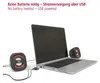 A laptop connected to two small speakers via USB. Produktbild-Vorschau