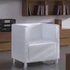 A white cube armchair is shown in a room with wooden furniture and shelves filled with books. Anteprima dell’immagine prodotto