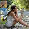 A woman reading a book by a river, with three inset images showing hiking, a stadium, and gardening. Produktbild-Vorschau