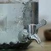 A close-up of a glass dispenser with a metal spigot, showing water being dispensed. Anteprima dell’immagine prodotto