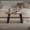 A coffee table with black metal legs sits on a textured rug in front of a sofa. Decorative items are on the table. Podgląd zdjęcia produktu