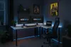 A gaming desk setup in a dimly lit room with LED lighting. Anteprima dell’immagine prodotto