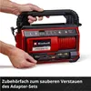 A person is holding a red and black Einhell hybrid compressor. Voir les images du produit