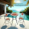 A patio set with a table and two chairs is placed on a deck overlooking a tropical ocean view with an infinity pool. Náhled obrázku produktu
