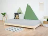 A child's bedroom with a wooden bed, pillows, and decorative mountain shapes on the wall. Produktbild-Vorschau
