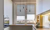 A modern kitchen with a window view of a city. Produktbild-Vorschau