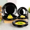 A set of black opal glass dinnerware, including plates and bowls, is displayed with food items. Anteprima dell’immagine prodotto