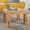 A wooden coffee table with a silver car figurine and a potted plant on it, placed in a living room with a yellow sofa in the background. Anteprima dell’immagine prodotto