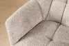 A close-up view of a textured, bouclé fabric chair in a neutral greige color. Produktbild-Vorschau