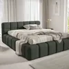 A bed with bedding in a room. Produktbild-Vorschau