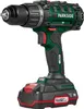 A cordless drill with battery pack and charger, shown from a side angle against a white background. Produktbild-Vorschau