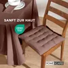 A close-up of a chair with a brown seat cushion next to a table covered with a brown tablecloth. Anteprima dell’immagine prodotto